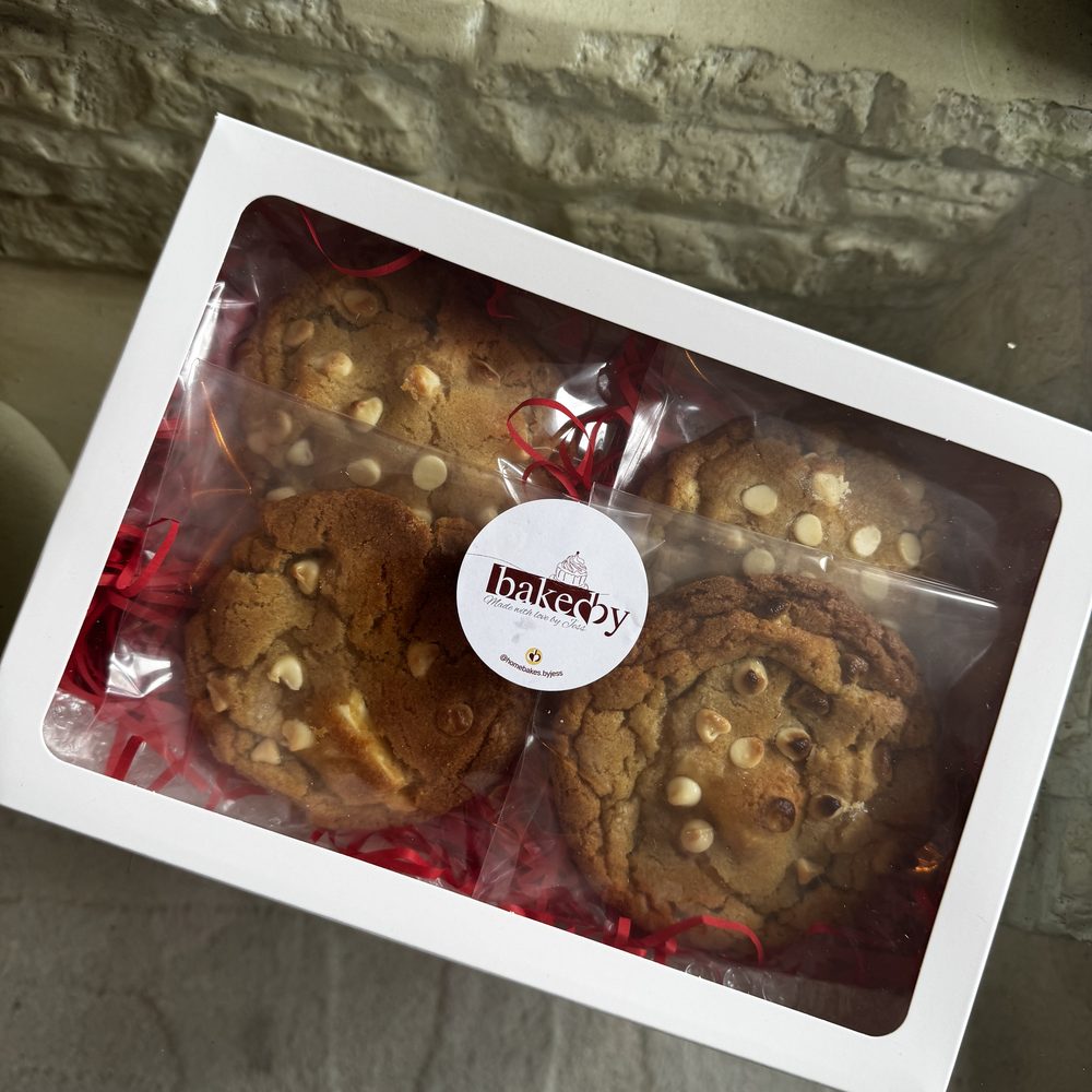 A branded gift box of Home Bakes by Jess white chocolate chip cookies